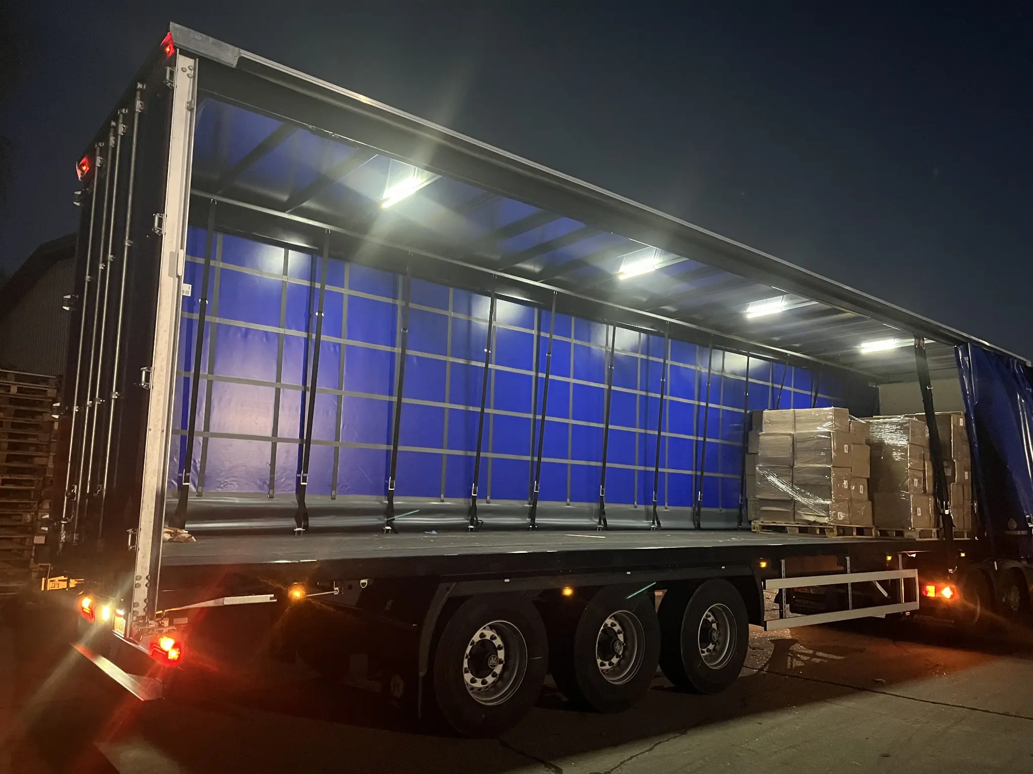 A customer-provided trailer being prepared during a night loading operation